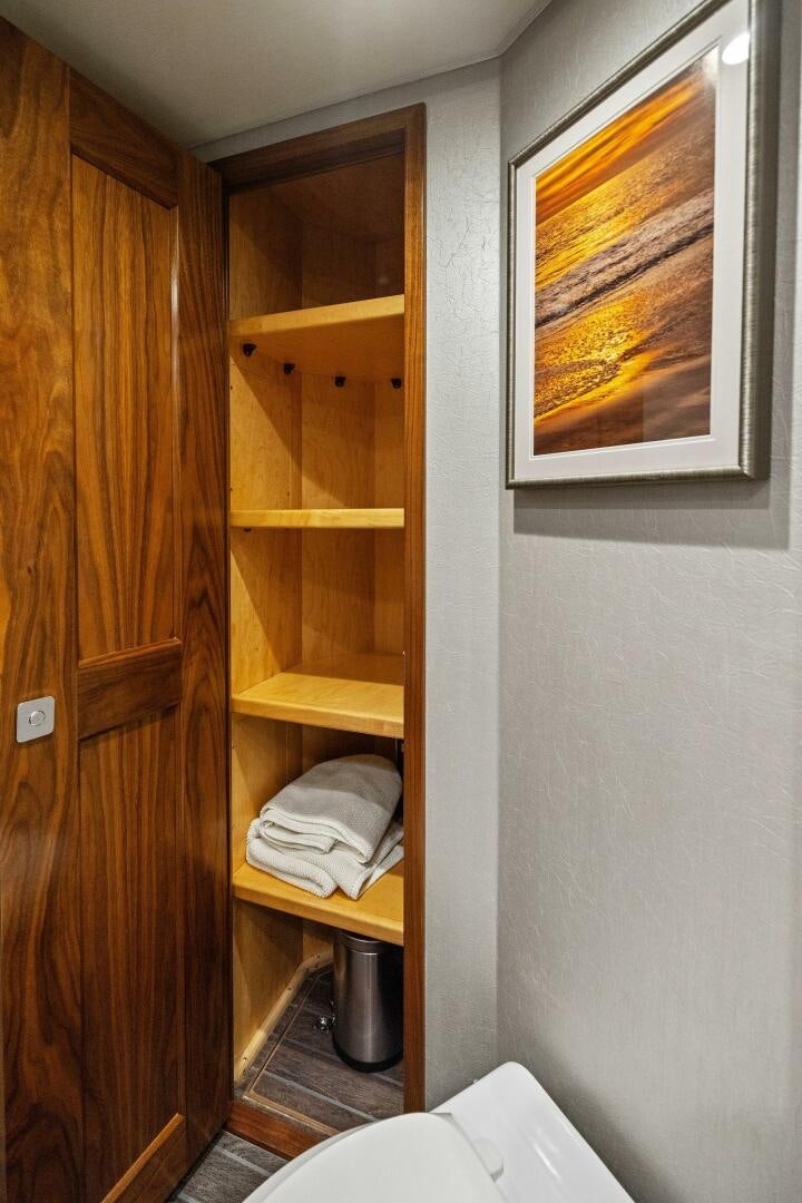 a wooden cabinet with a mirror above it aboard PLAN B Yacht for Sale