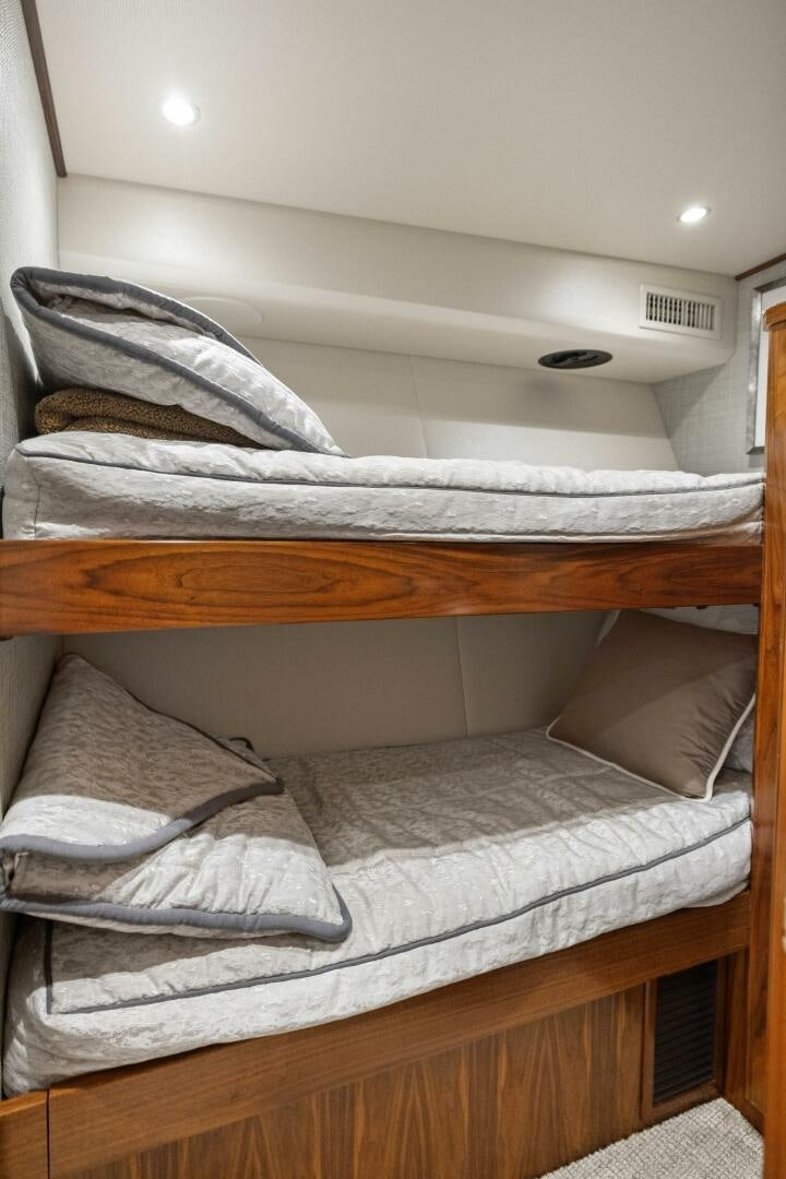 a bed with white sheets aboard PLAN B Yacht for Sale