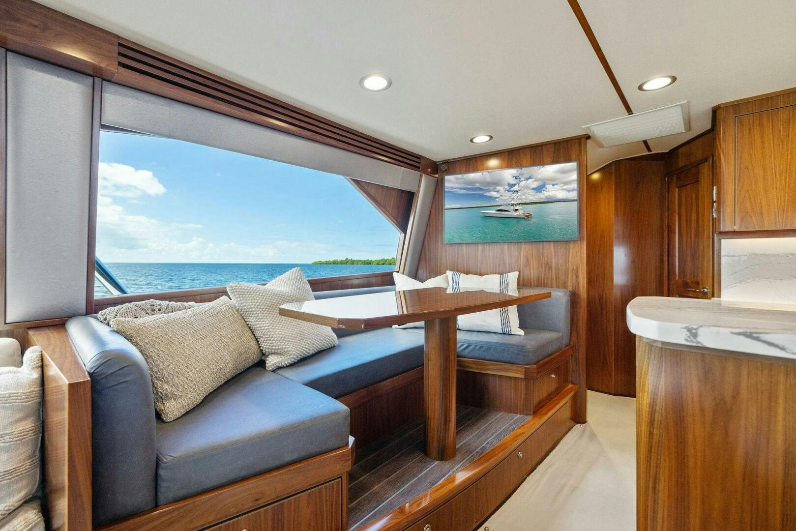 a large living room with a large window aboard PLAN B Yacht for Sale