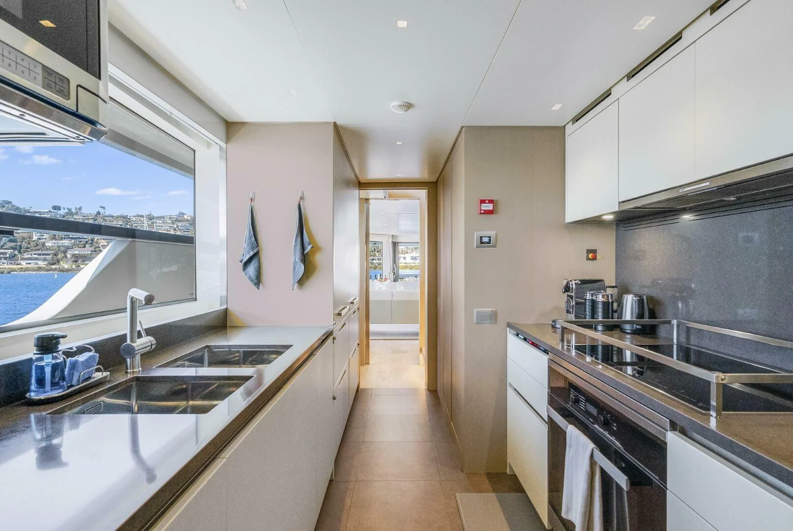 a kitchen with a large window aboard GENOA Yacht for Sale