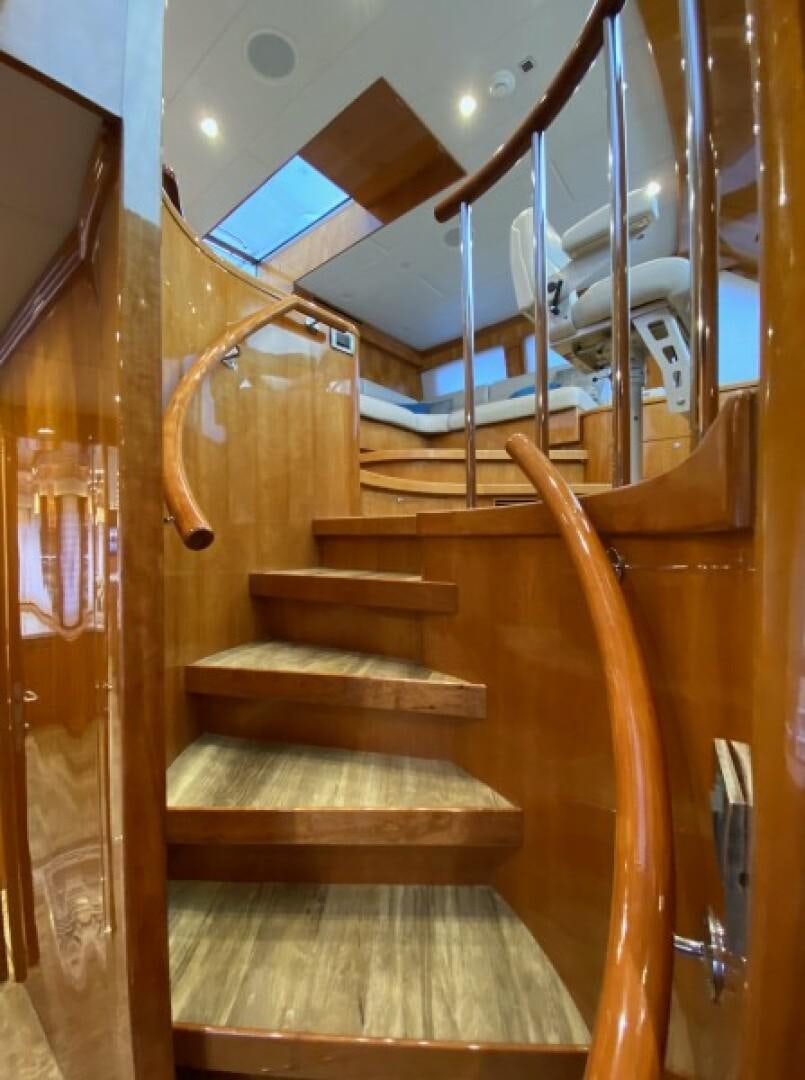 a wooden staircase with glass doors aboard BRANDI WINE Yacht for Sale