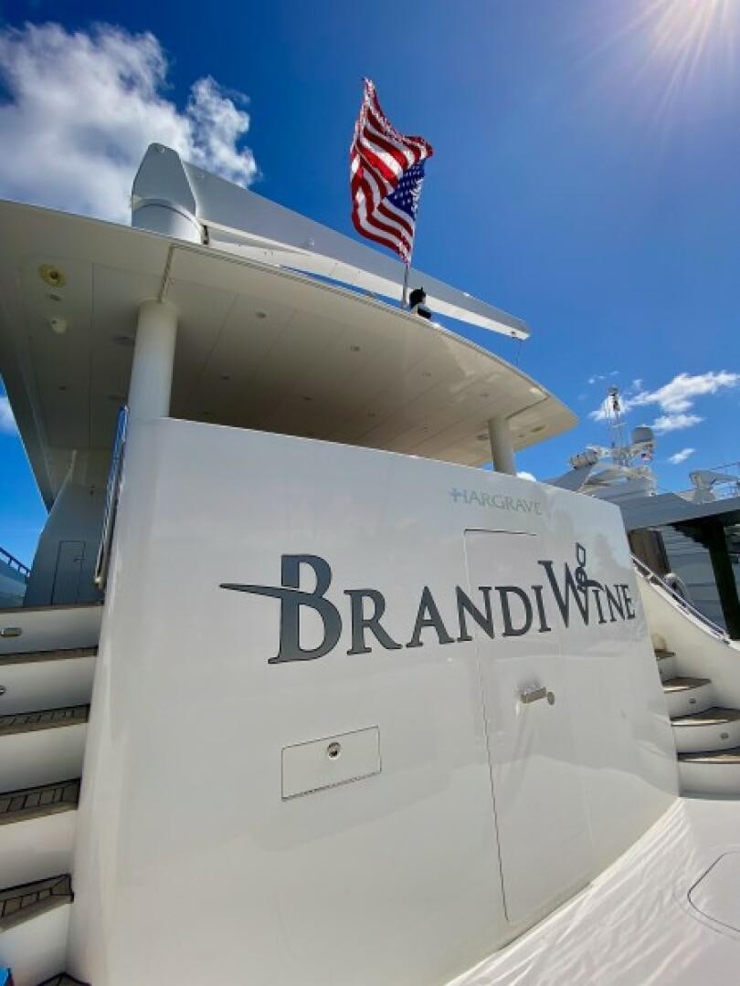 a large white ship with a flag on top aboard BRANDI WINE Yacht for Sale