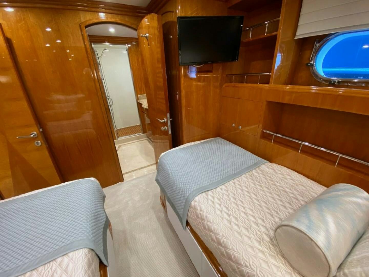 a room with a bed and a television on the wall aboard BRANDI WINE Yacht for Sale