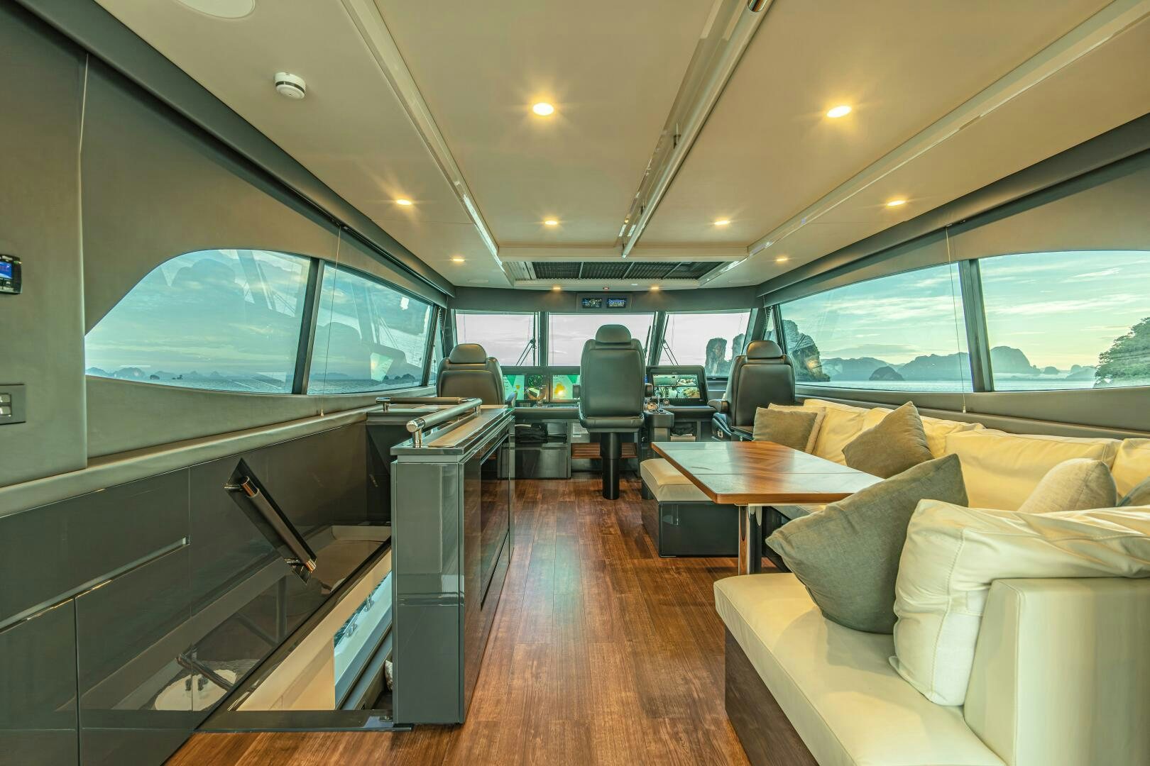 inside of a vehicle with a table and chairs and a couch aboard BIG MAMA Yacht for Sale
