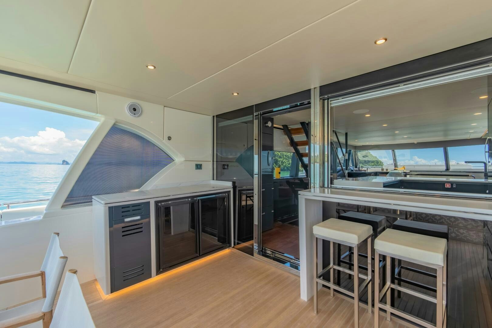a room with a large window and a view of the ocean aboard BIG MAMA Yacht for Sale