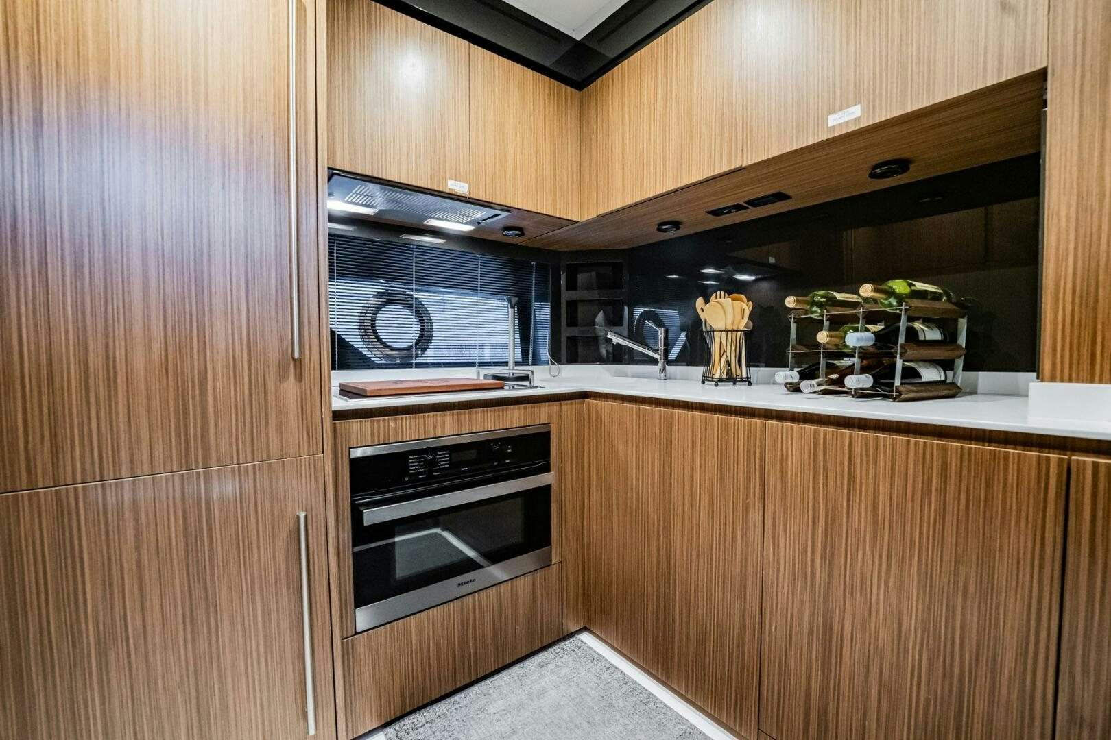 a kitchen with wooden cabinets aboard RECREATIONAL USE Yacht for Sale
