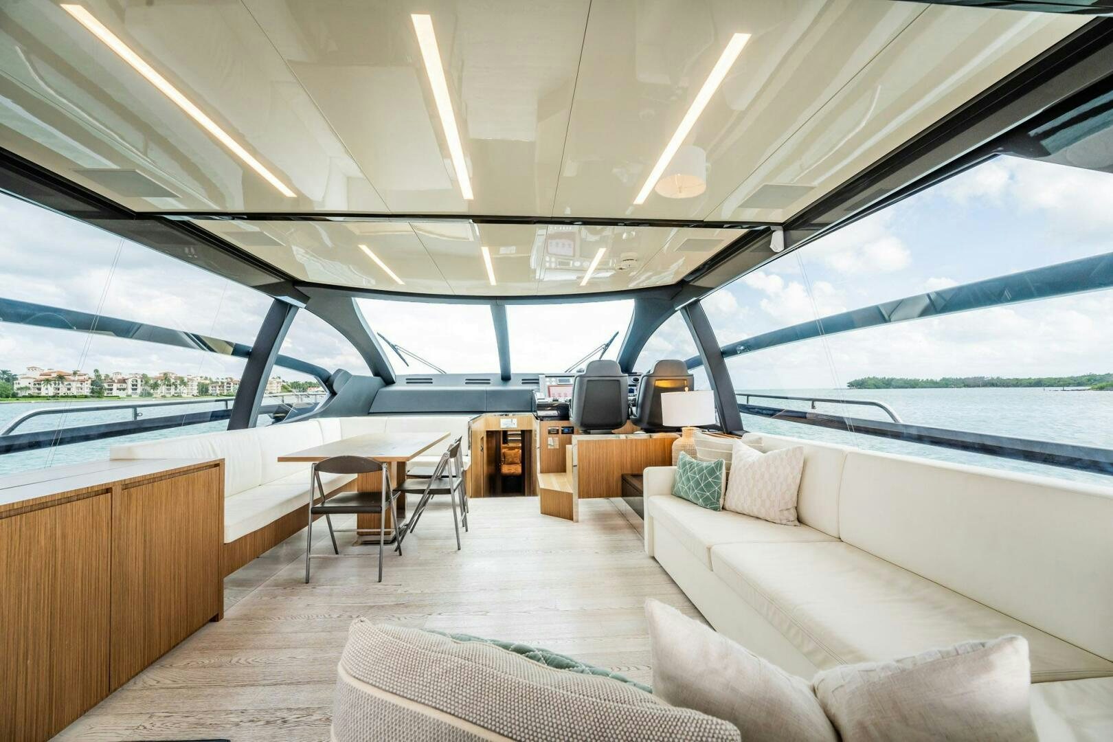 a room with a couch and a table and a large window aboard RECREATIONAL USE Yacht for Sale
