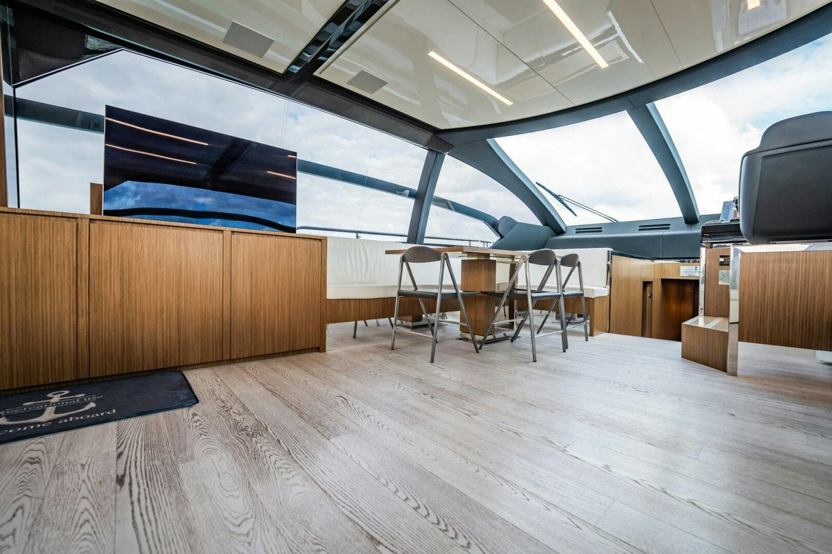 a room with a wood floor and chairs and a tv aboard RECREATIONAL USE Yacht for Sale