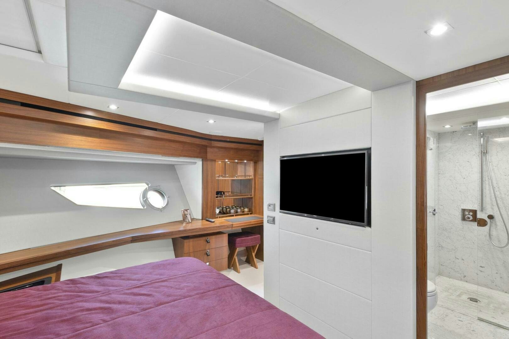 a bedroom with a bed and a television aboard ALEXA Yacht for Sale