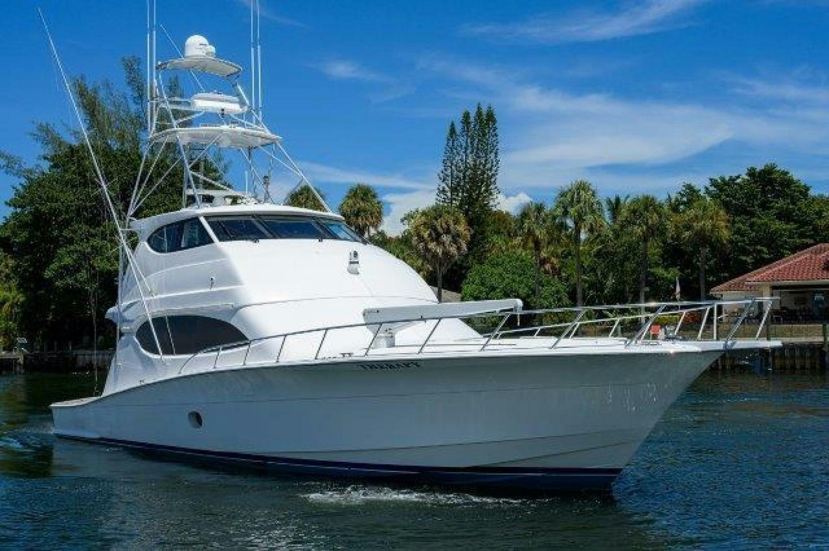 a white yacht in a harbor aboard BUZZ Yacht for Sale