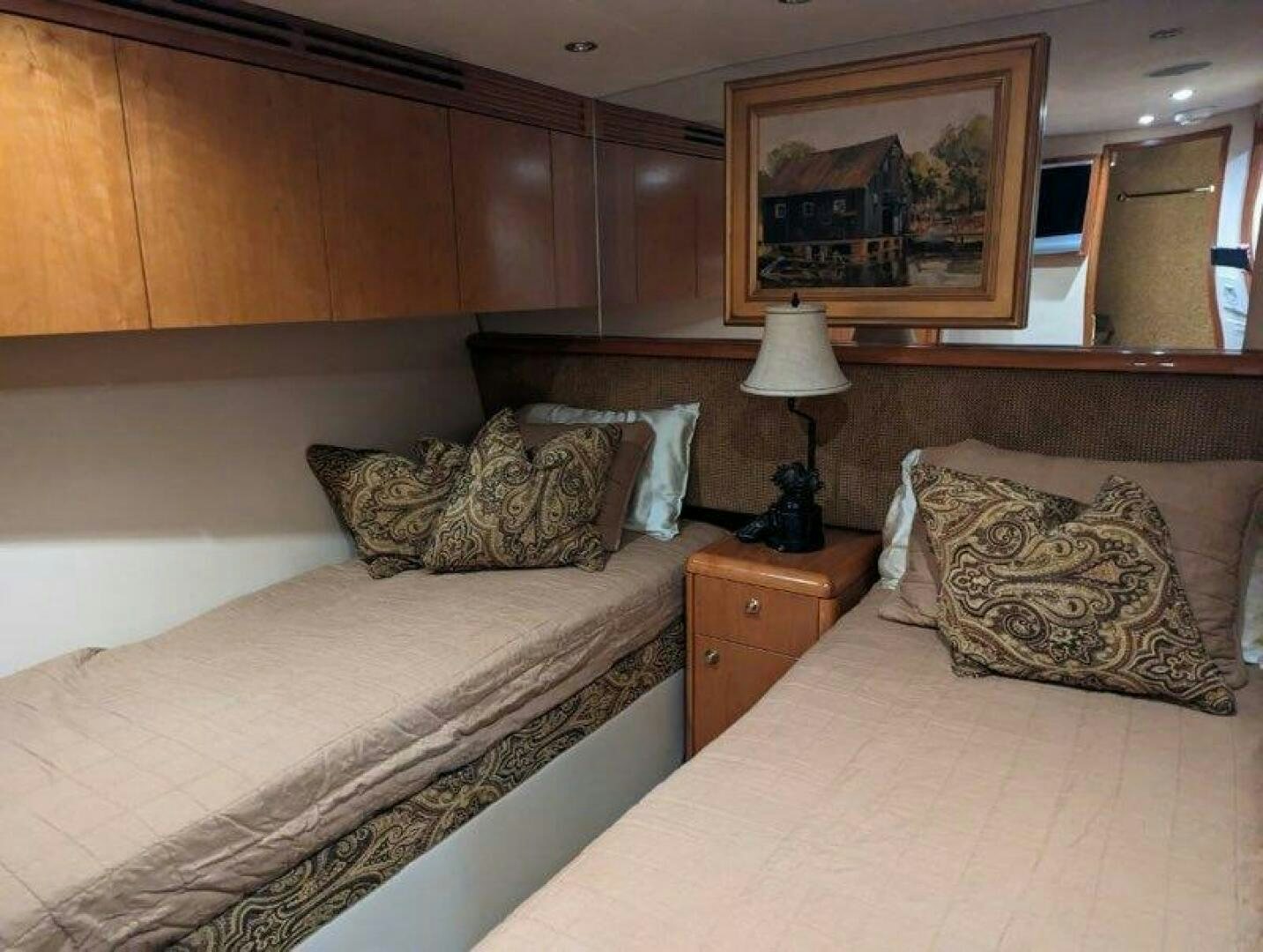 a bedroom with a bed and a dresser aboard BUZZ Yacht for Sale