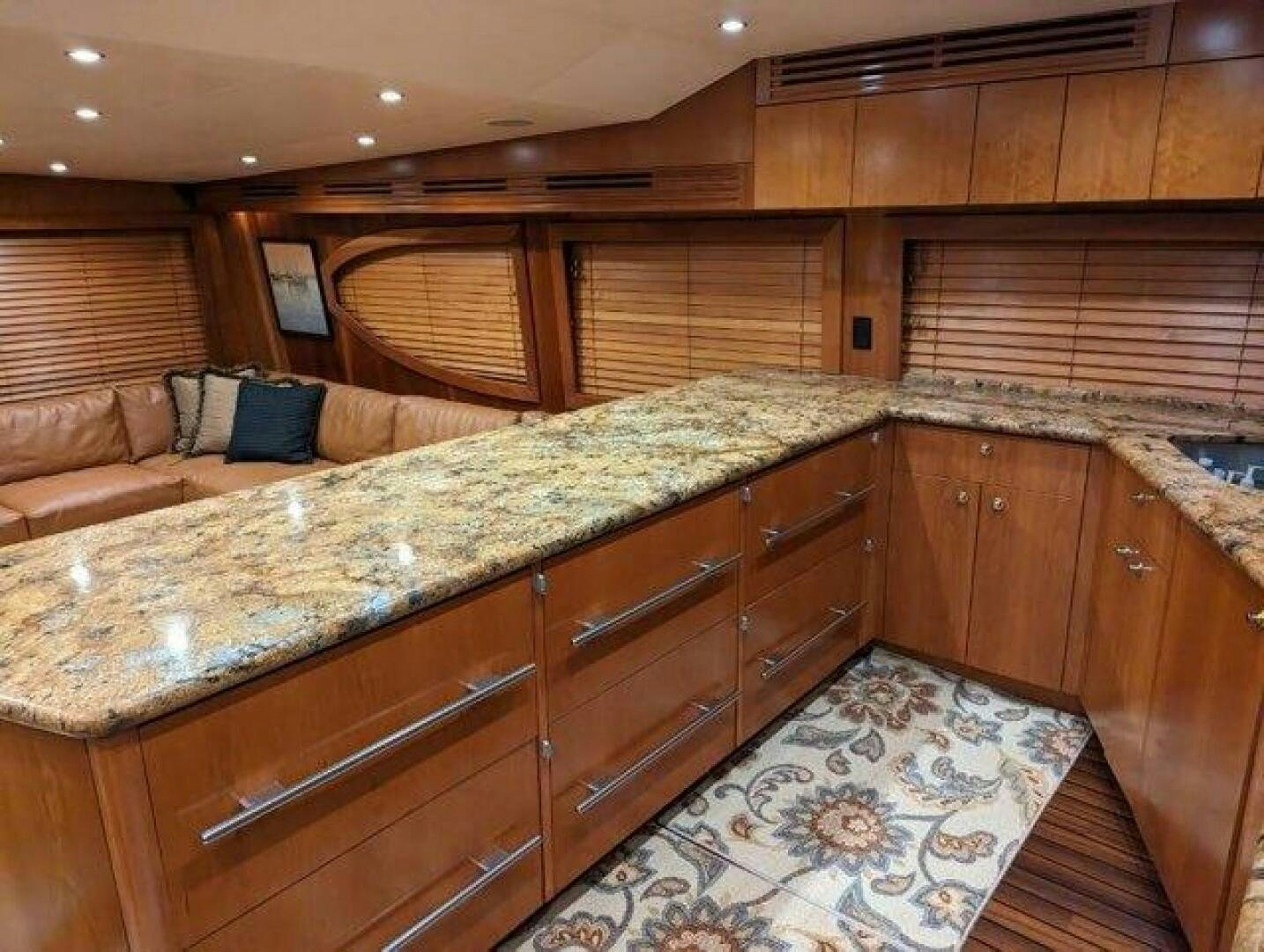 a large kitchen with wooden cabinets aboard BUZZ Yacht for Sale