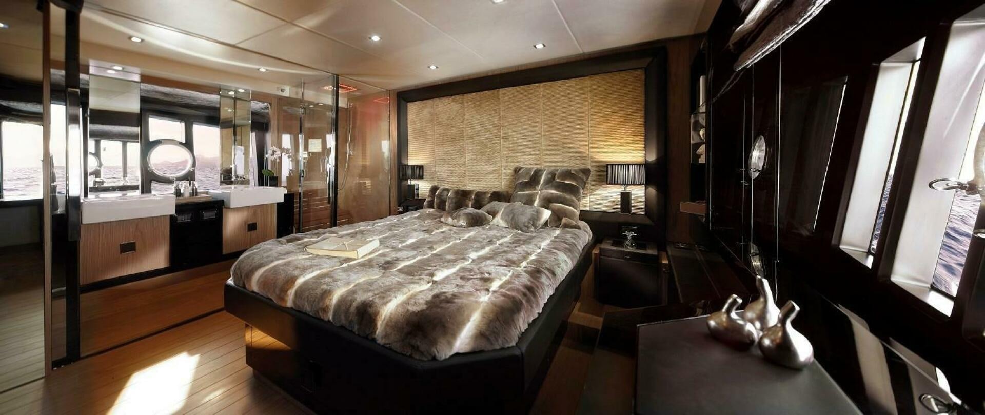 a bedroom with a bed and a desk aboard C68 Yacht for Sale