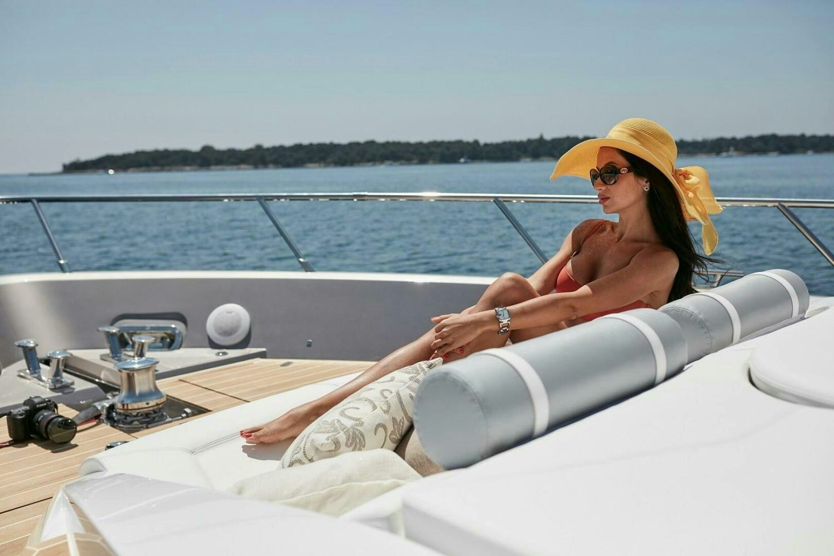 a woman in a yellow hat on a boat aboard C68 Yacht for Sale
