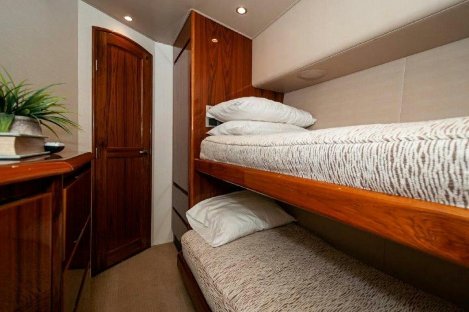 a bedroom with a bed and a desk aboard POUR INTENTIONS Yacht for Sale