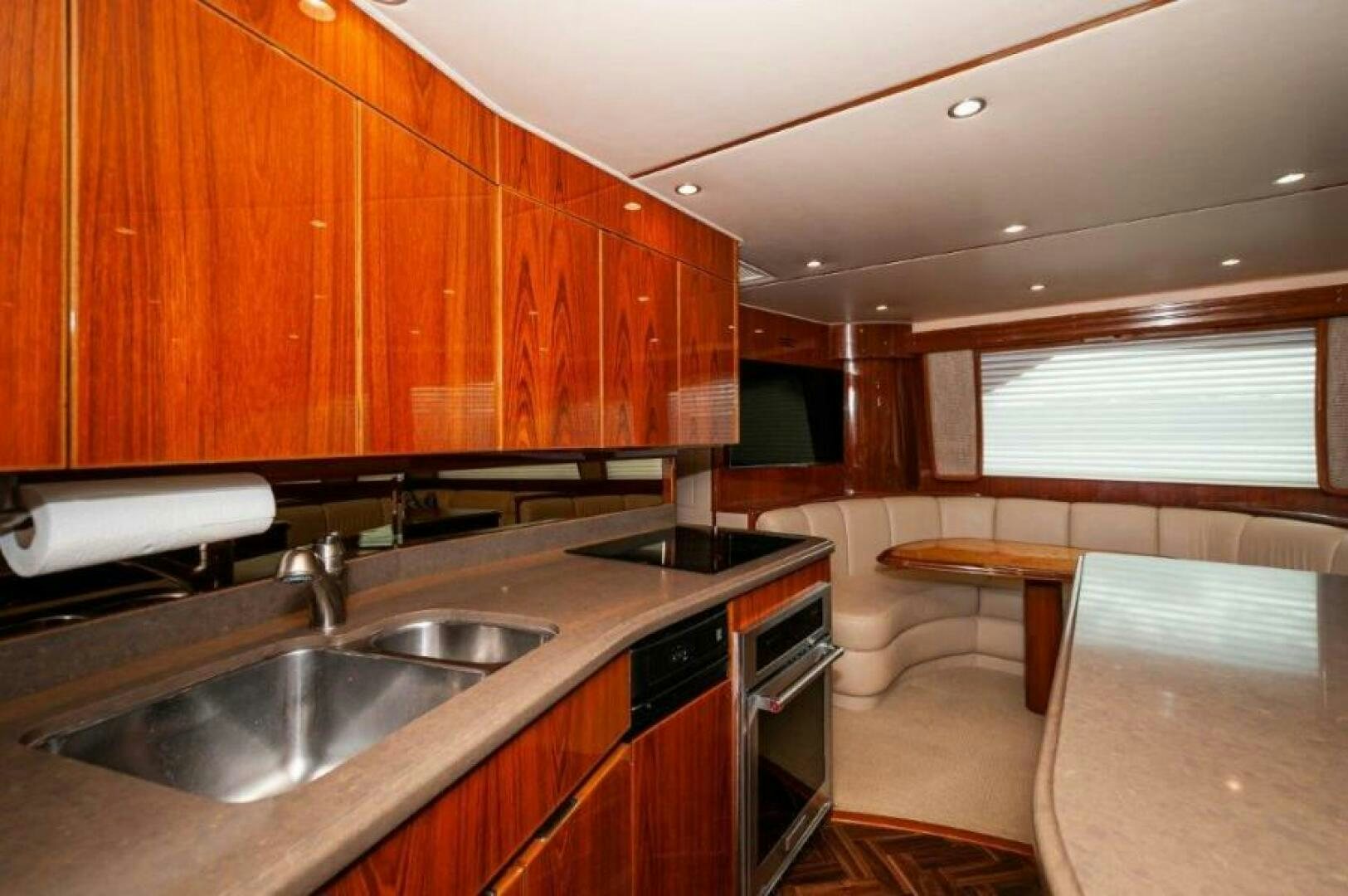 a kitchen with wooden cabinets aboard POUR INTENTIONS Yacht for Sale