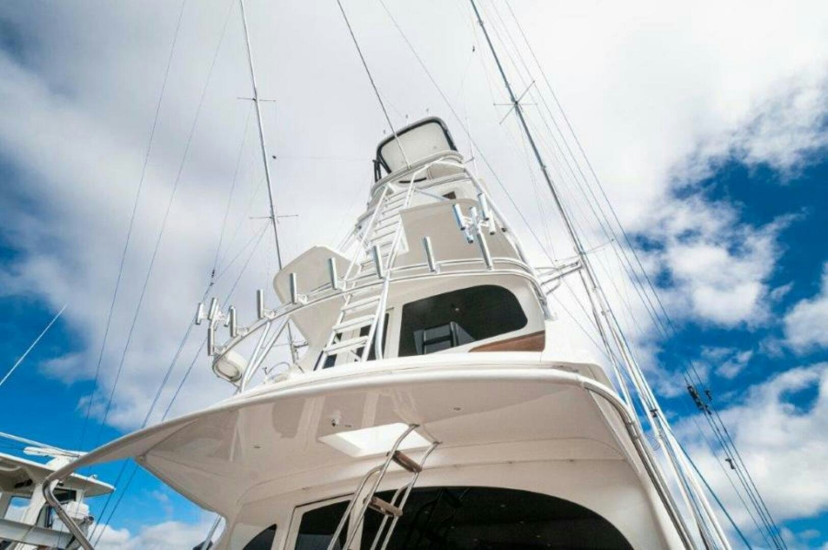 a white boat on a cloudy day aboard POUR INTENTIONS Yacht for Sale