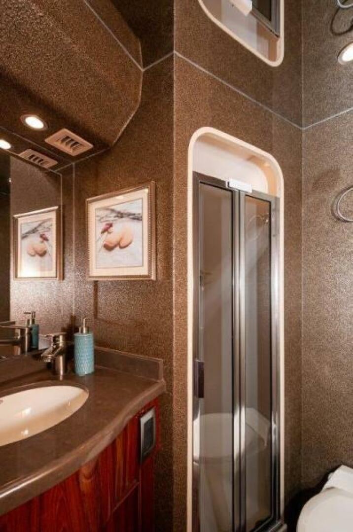a bathroom with a sink and a mirror aboard POUR INTENTIONS Yacht for Sale