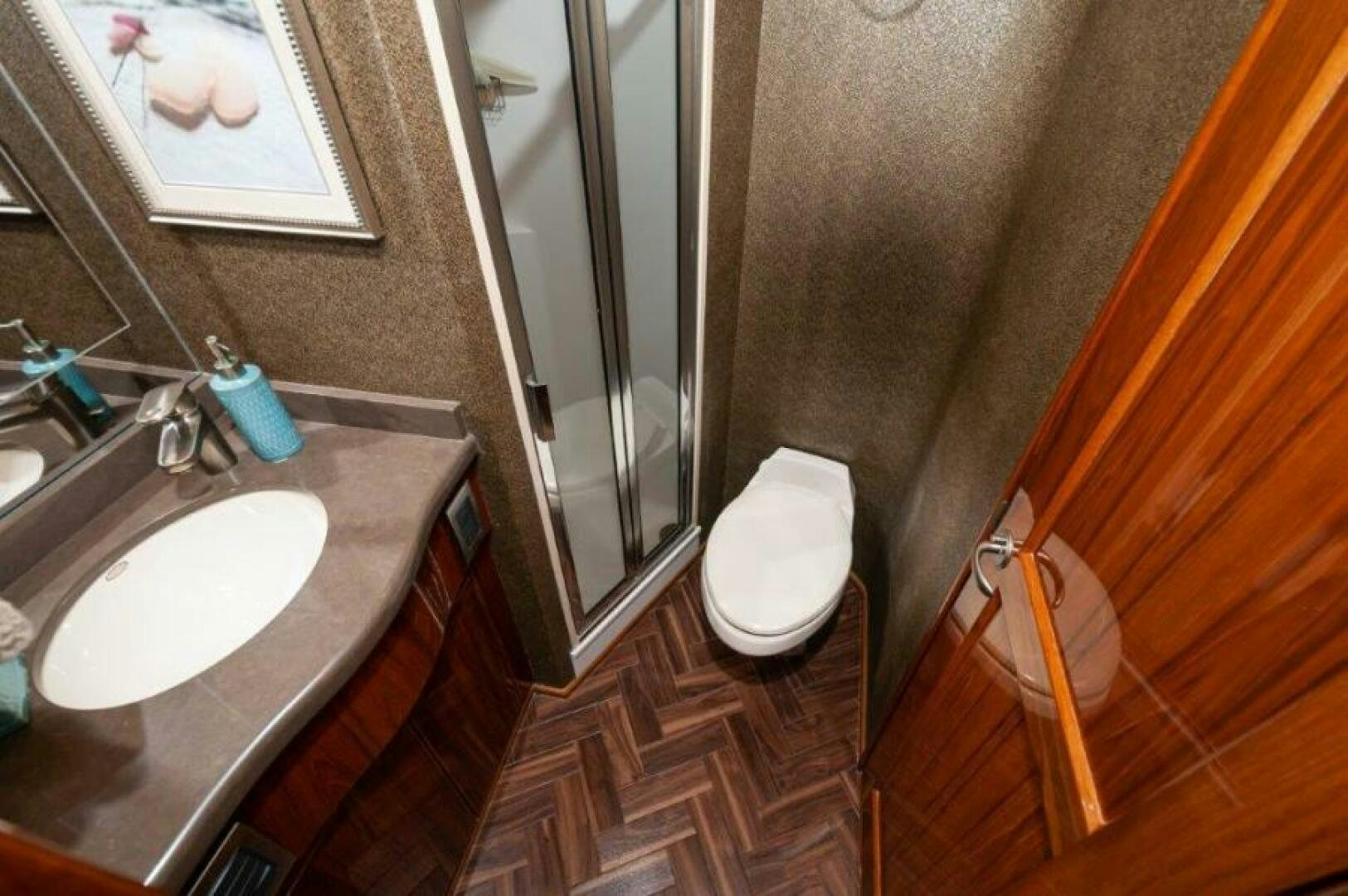 a bathroom with a sink and toilet aboard POUR INTENTIONS Yacht for Sale