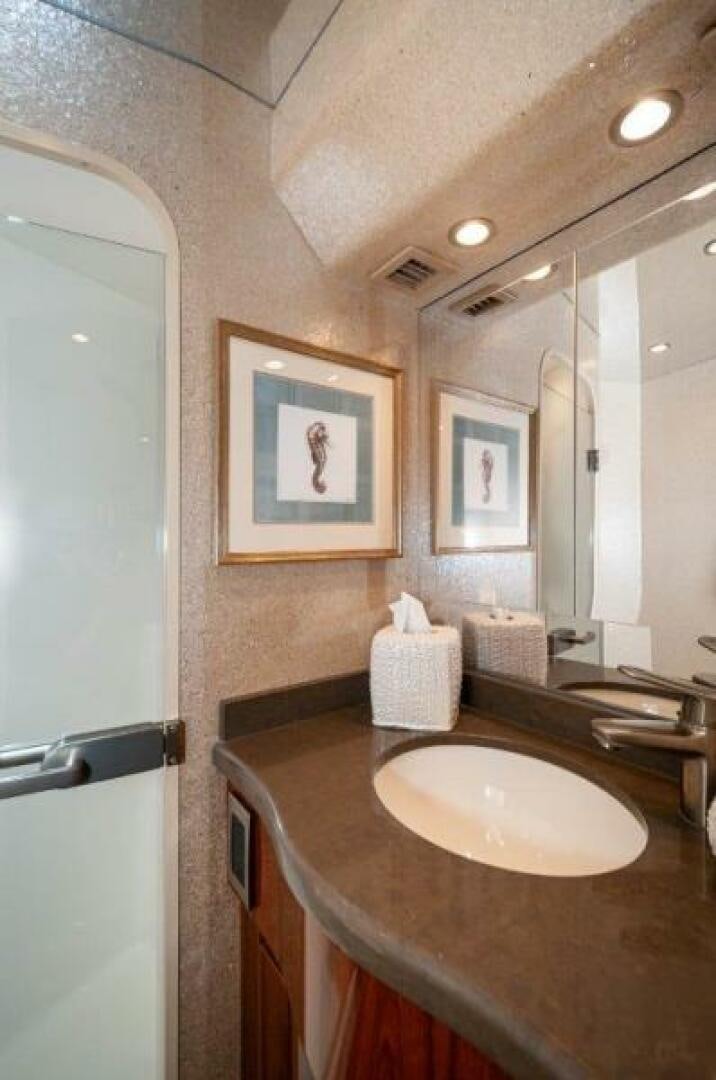 a bathroom with a sink and a mirror aboard POUR INTENTIONS Yacht for Sale