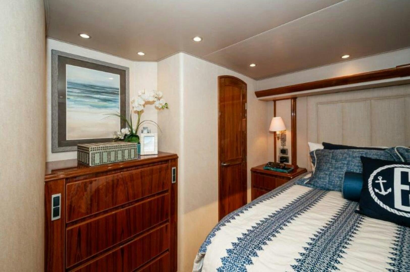 a bedroom with a bed and a desk aboard POUR INTENTIONS Yacht for Sale
