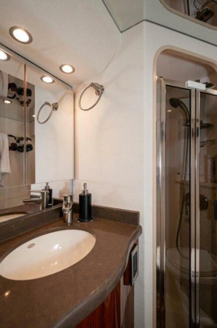 a bathroom with a shower and sink aboard POUR INTENTIONS Yacht for Sale