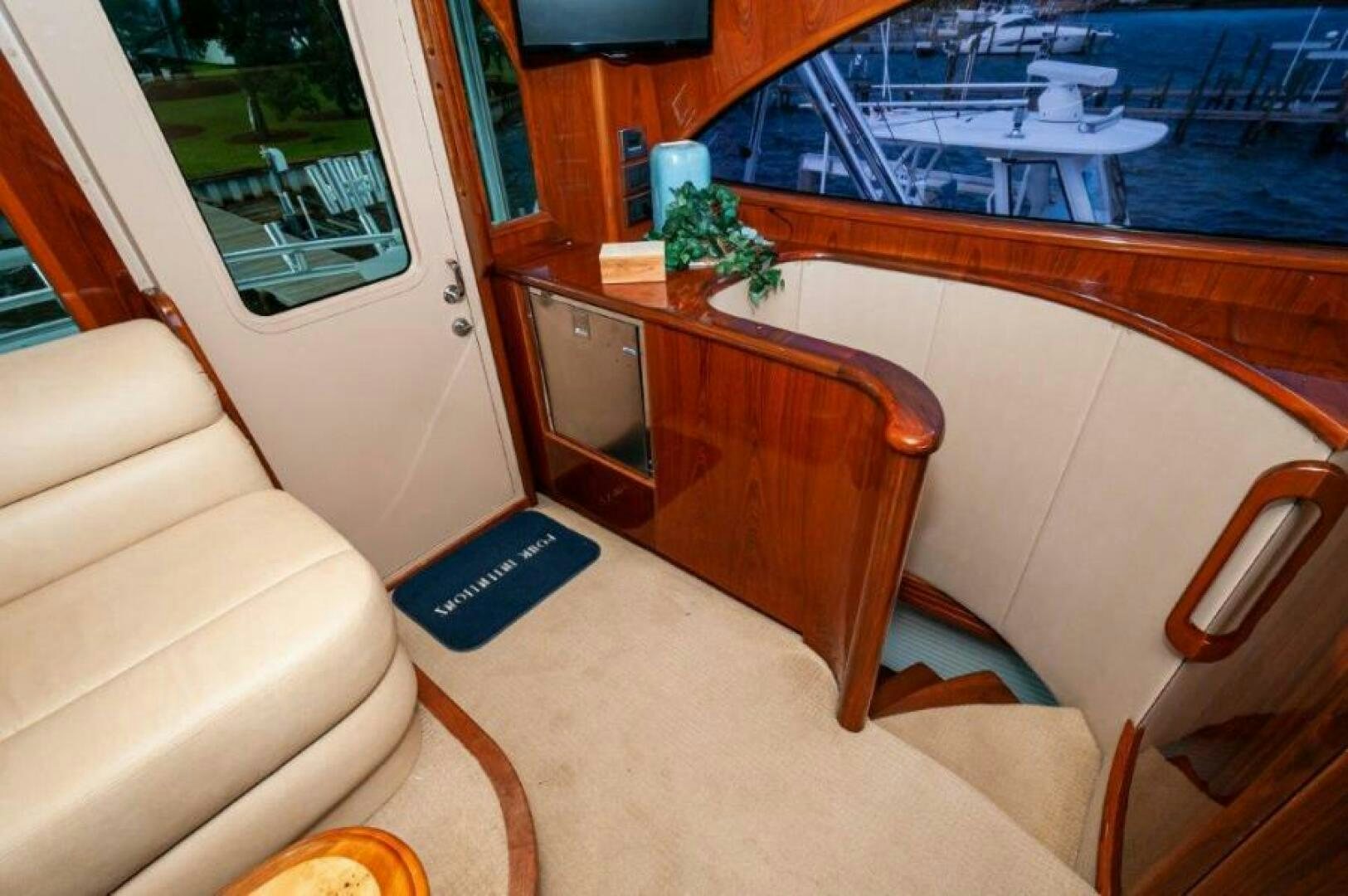 a living room with a large table and chairs aboard POUR INTENTIONS Yacht for Sale