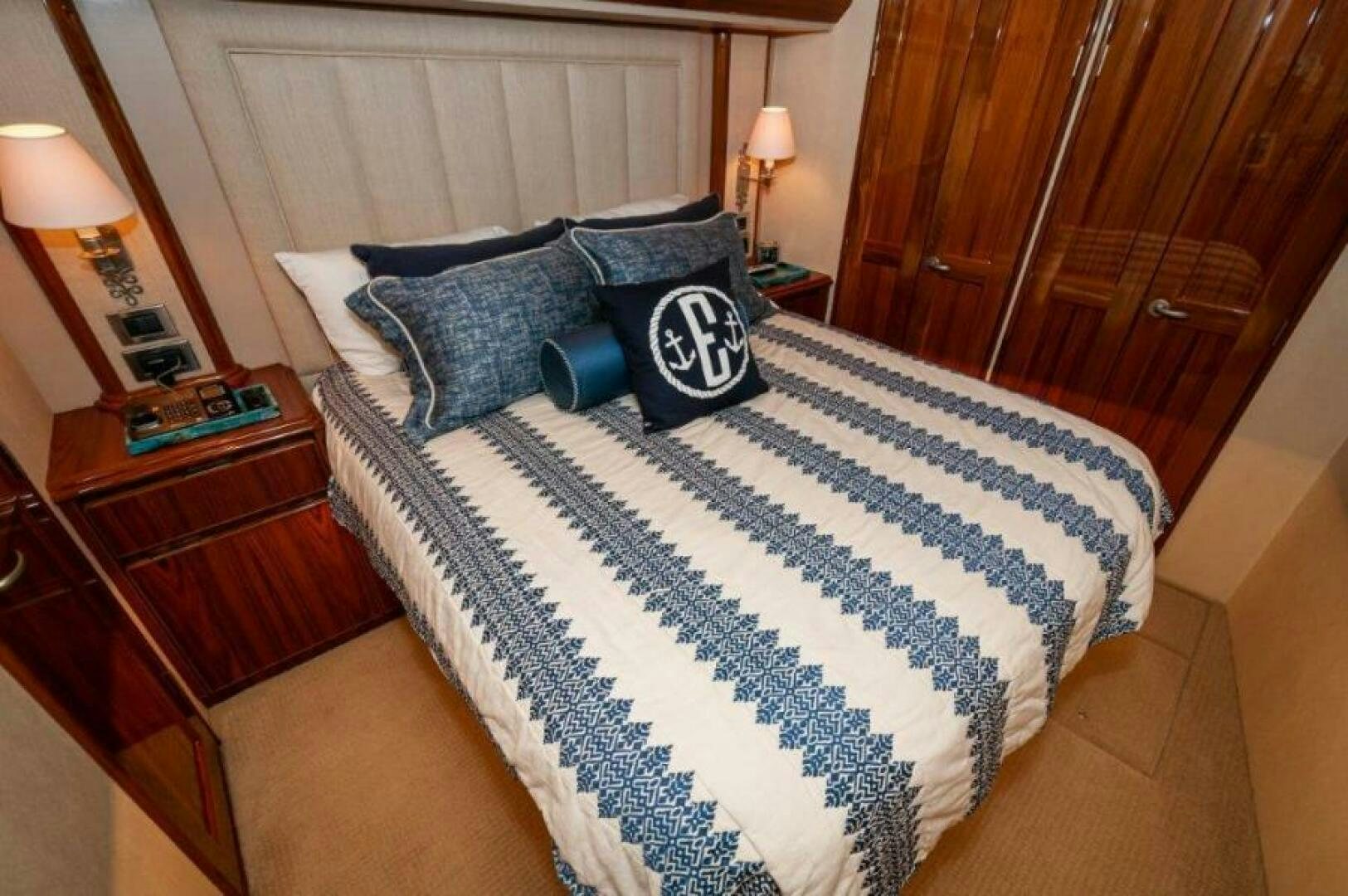 a bed with blue and white sheets aboard POUR INTENTIONS Yacht for Sale