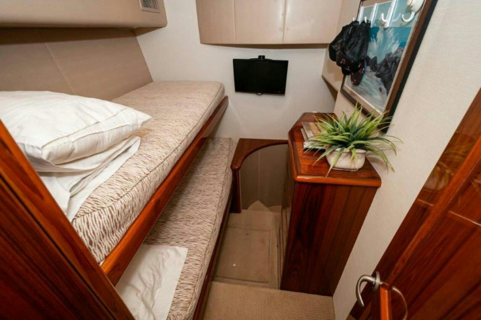 a room with a bed and a table aboard POUR INTENTIONS Yacht for Sale