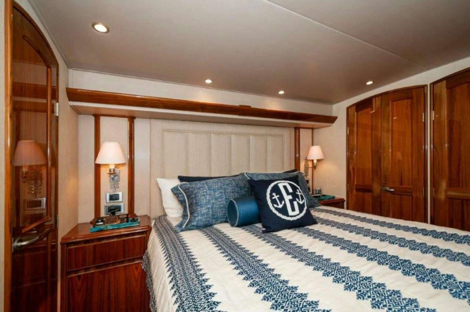 a hotel room with a bed and a lamp aboard POUR INTENTIONS Yacht for Sale