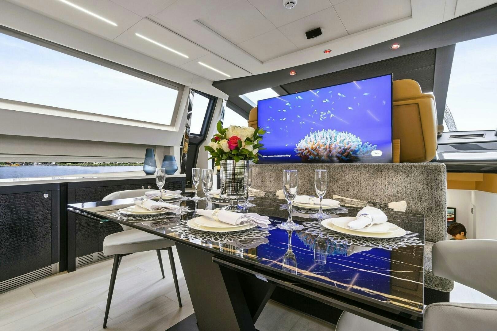a large table with plates and glasses aboard GYPSEA Yacht for Sale