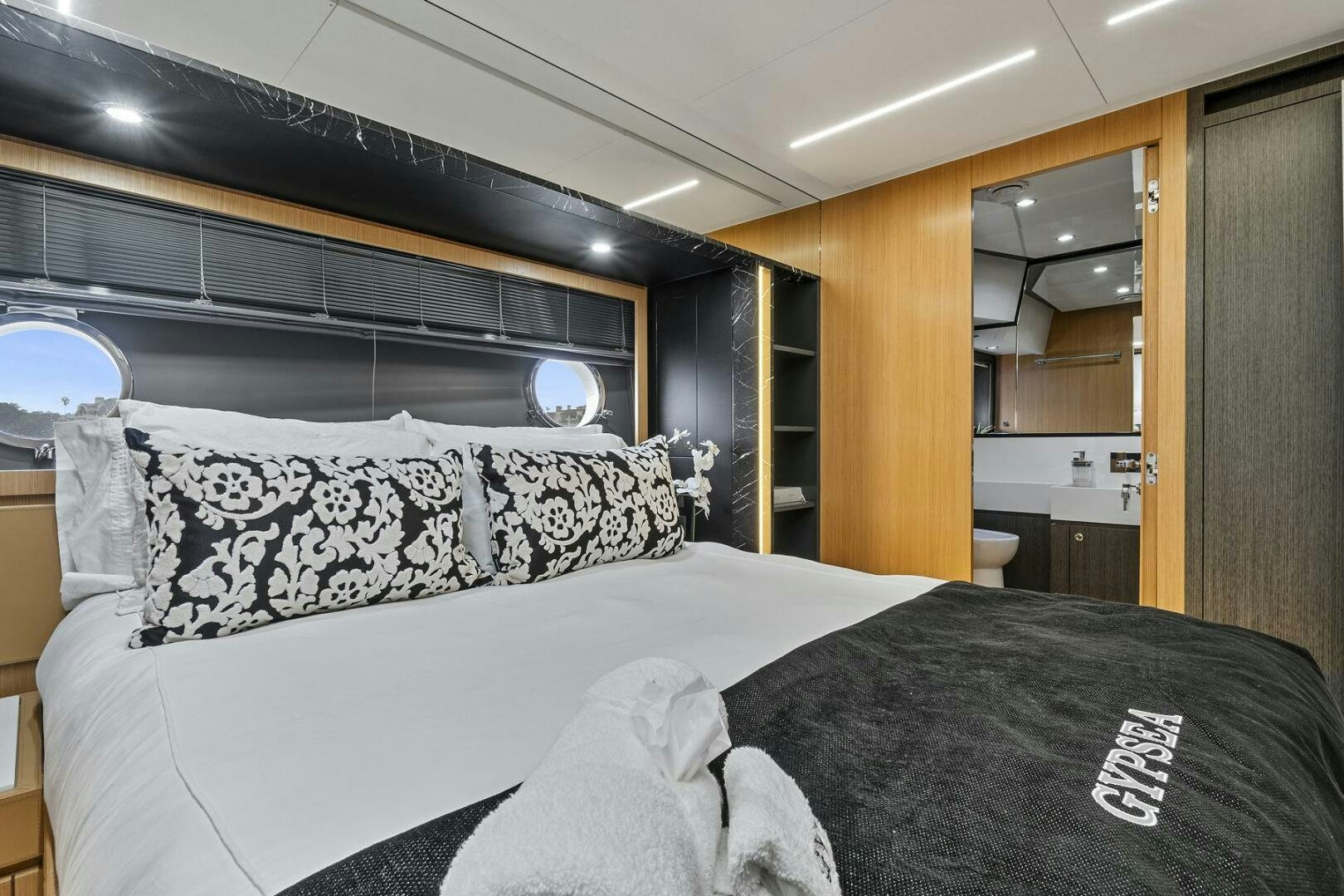a bed with white sheets aboard GYPSEA Yacht for Sale