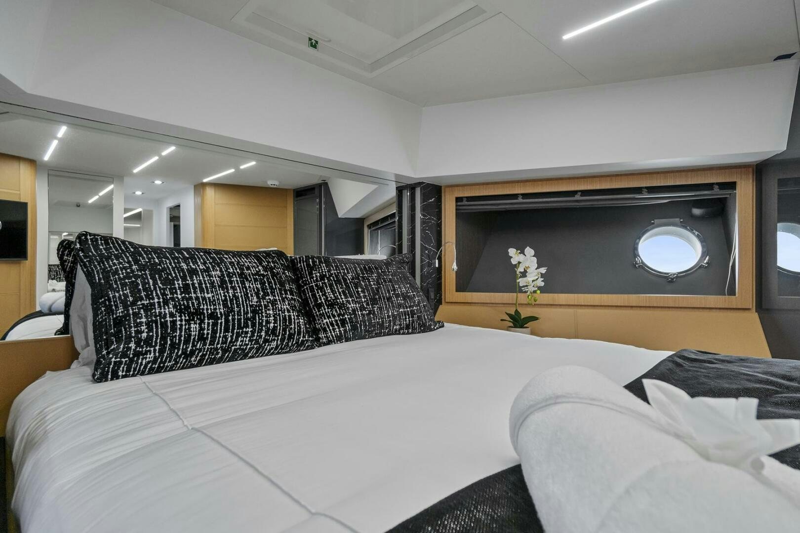a bed with a white bed spread aboard GYPSEA Yacht for Sale