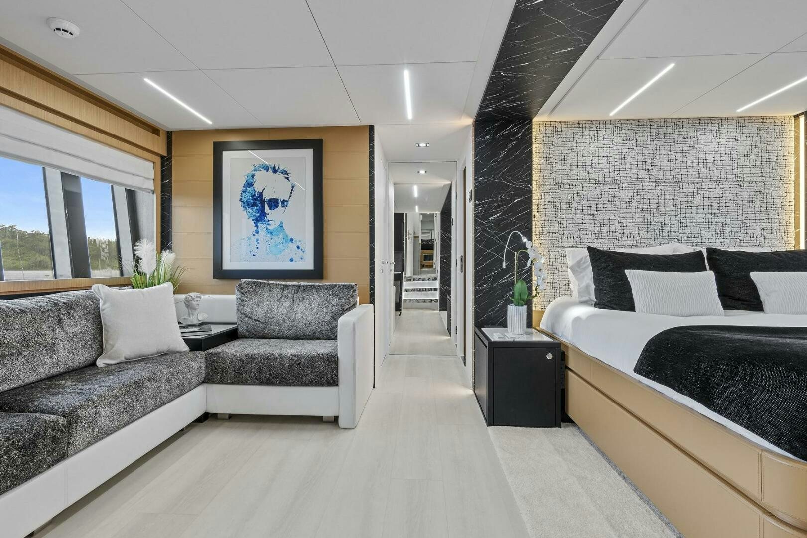 a modern looking bedroom with a large bed and a large window aboard GYPSEA Yacht for Sale