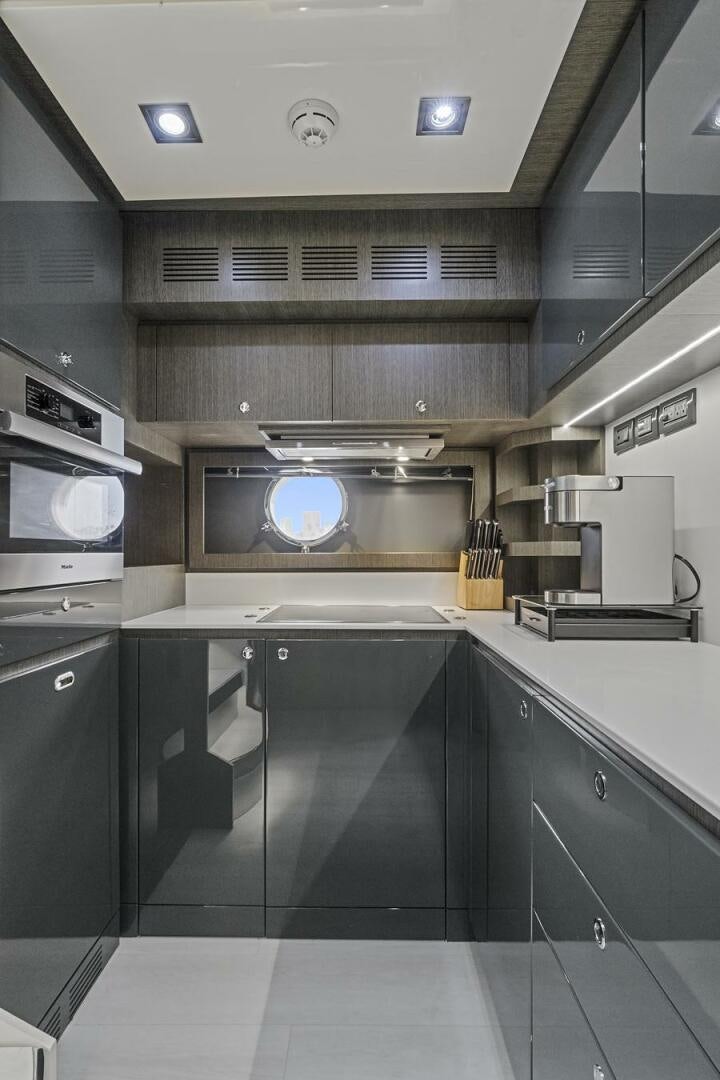 a kitchen with black cabinets aboard GYPSEA Yacht for Sale