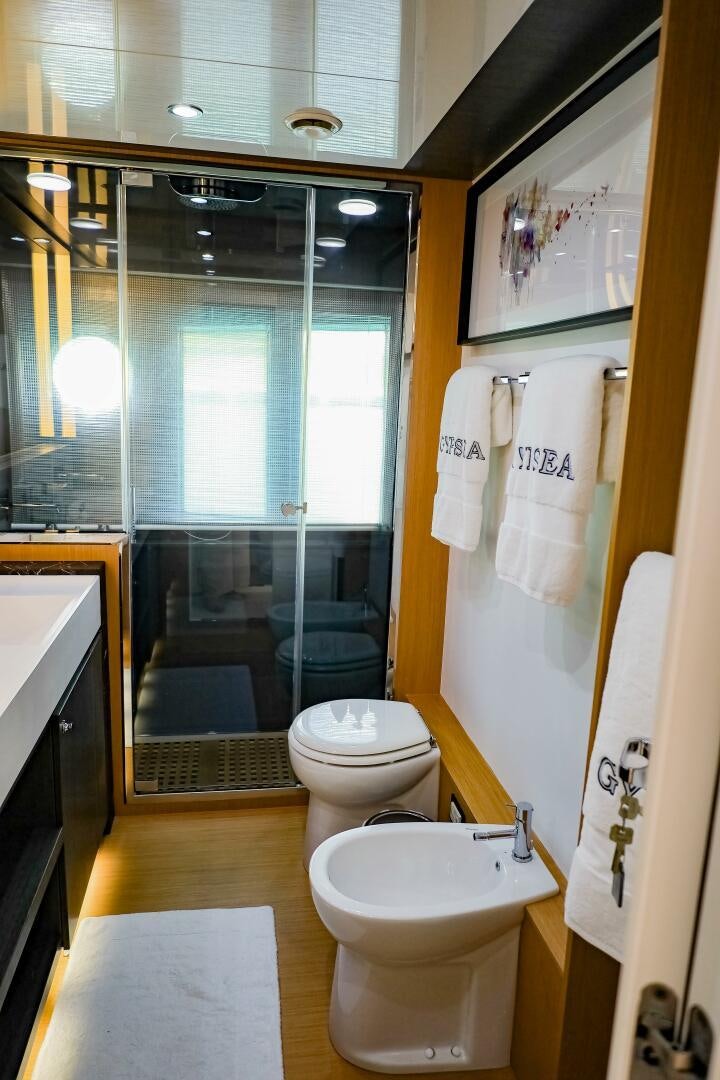 a bathroom with a glass shower door aboard GYPSEA Yacht for Sale