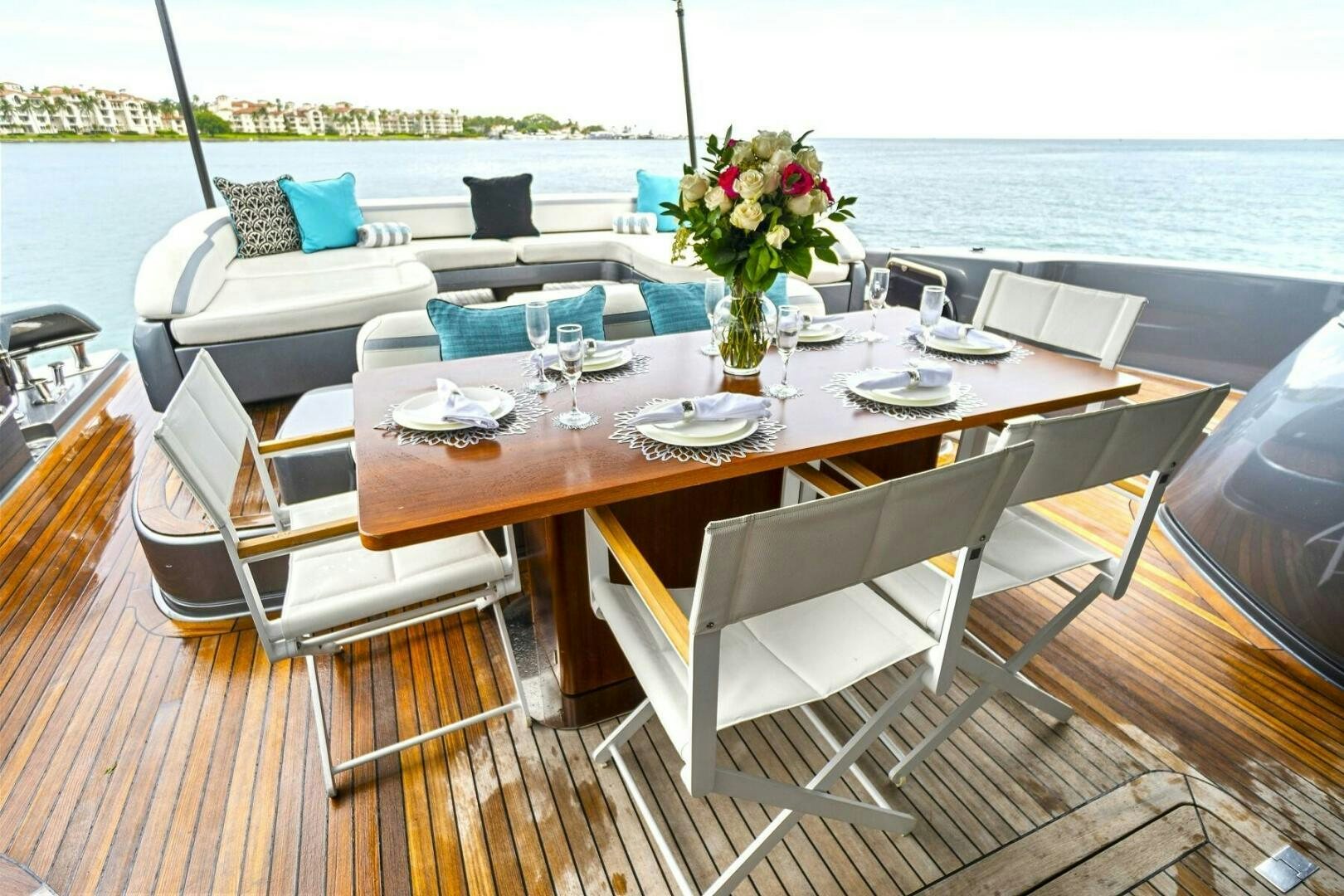 a table with chairs and a vase of flowers on it aboard GYPSEA Yacht for Sale