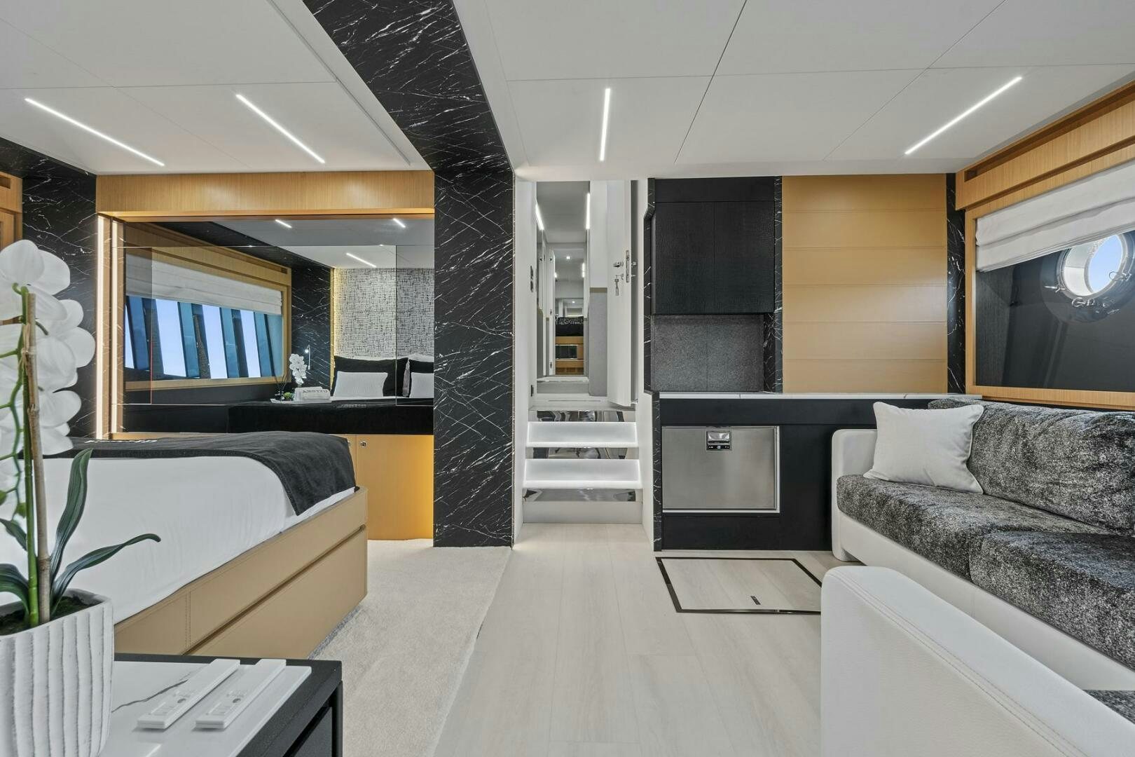 a room with a bed and a couch aboard GYPSEA Yacht for Sale