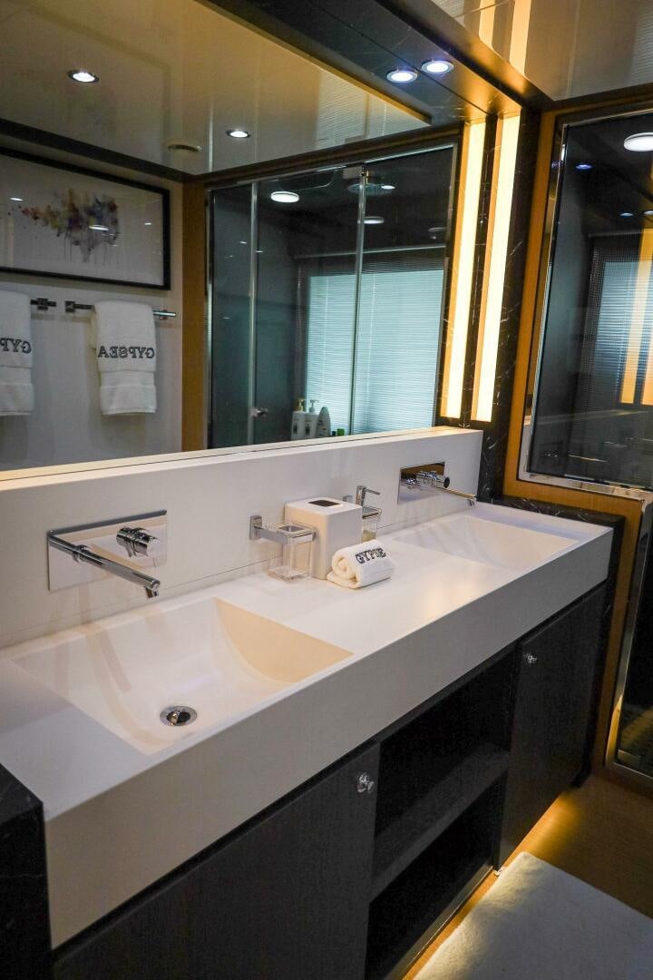 a bathroom with a large mirror aboard GYPSEA Yacht for Sale