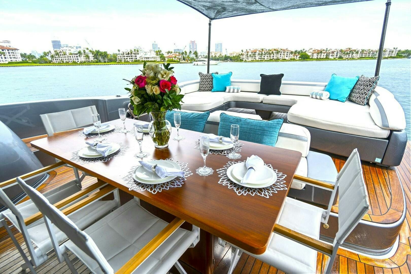a table with chairs and a vase with flowers on it aboard GYPSEA Yacht for Sale