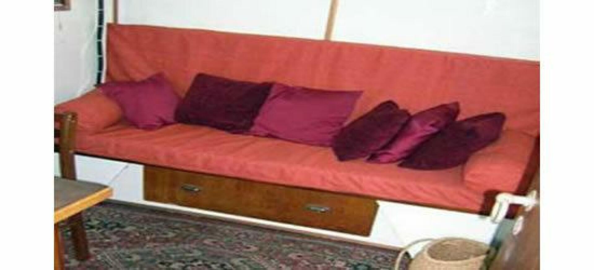 a bed with red pillows aboard HAGANES Yacht for Sale