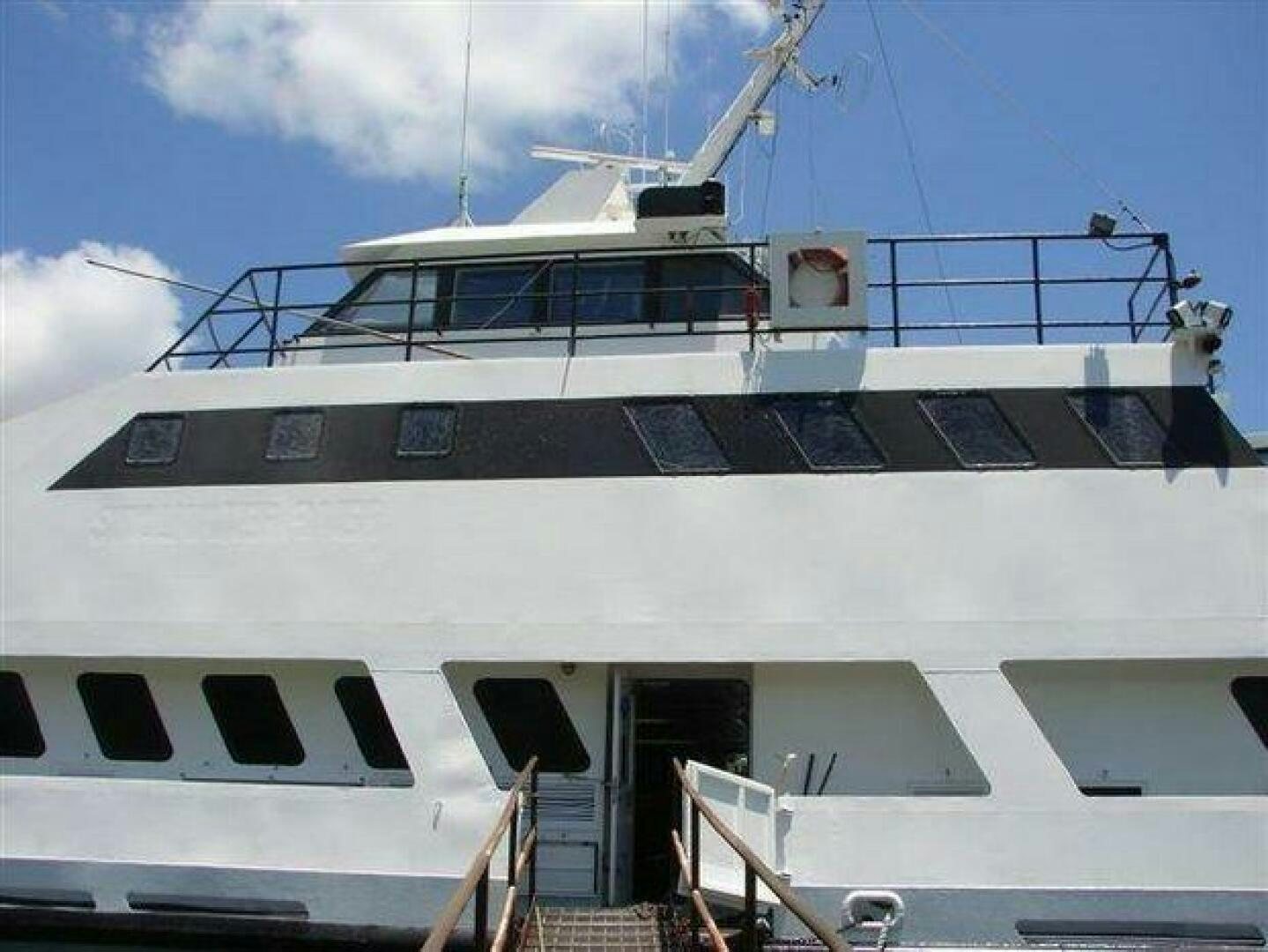 a large cruise ship docked aboard STILLWATER RIVER Yacht for Sale