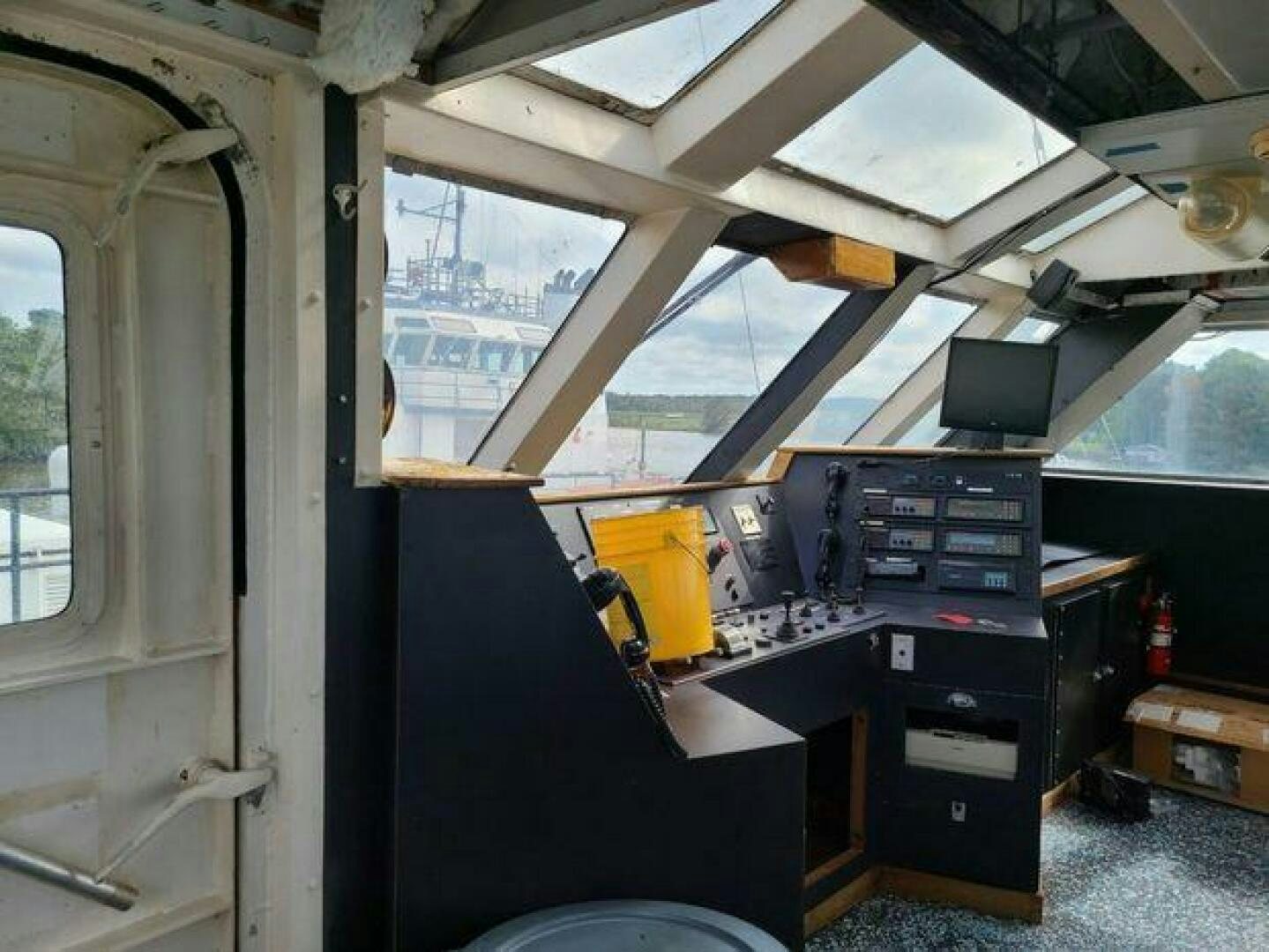 a room with a large window and a desk with a computer on it aboard STILLWATER RIVER Yacht for Sale