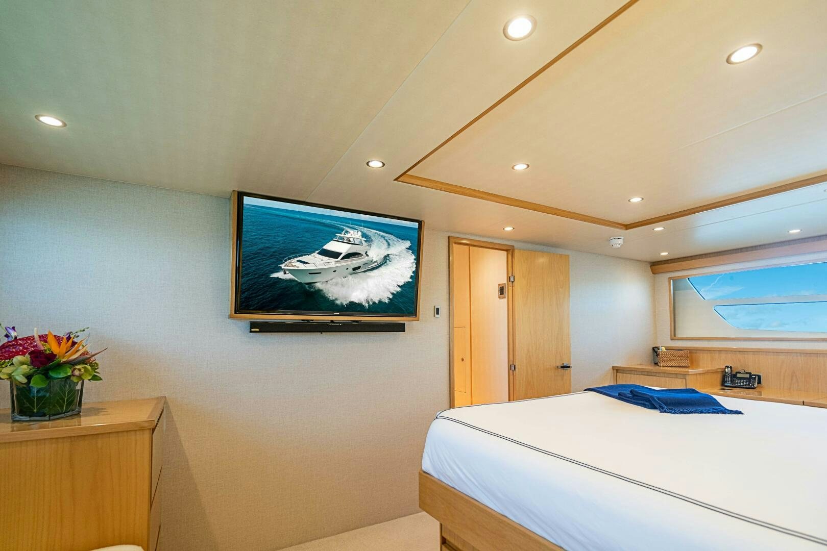 a bedroom with a bed and a television on the wall aboard MARYBELLE Yacht for Sale