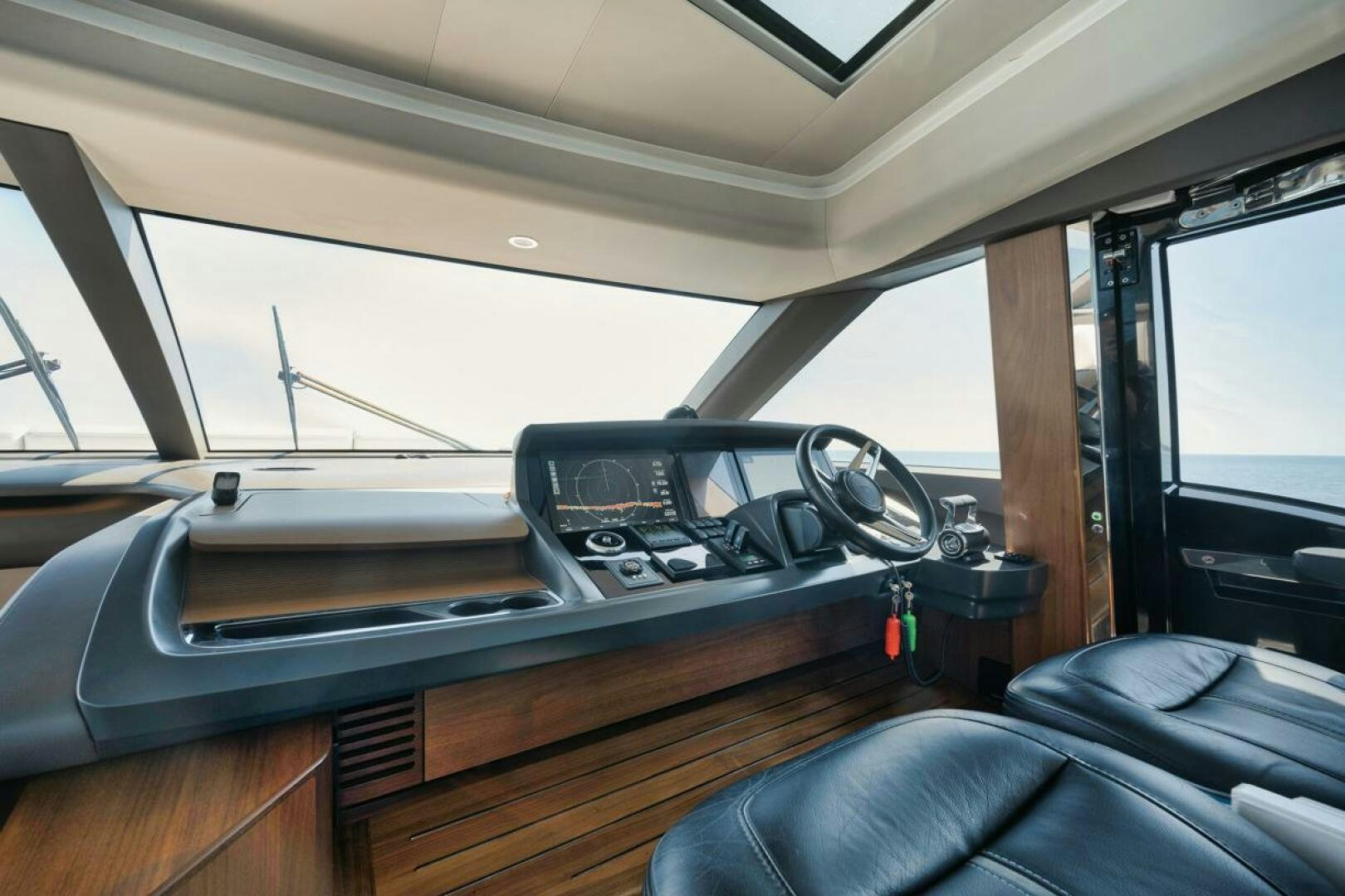 a car with a steering wheel aboard HOOKED HER Yacht for Sale