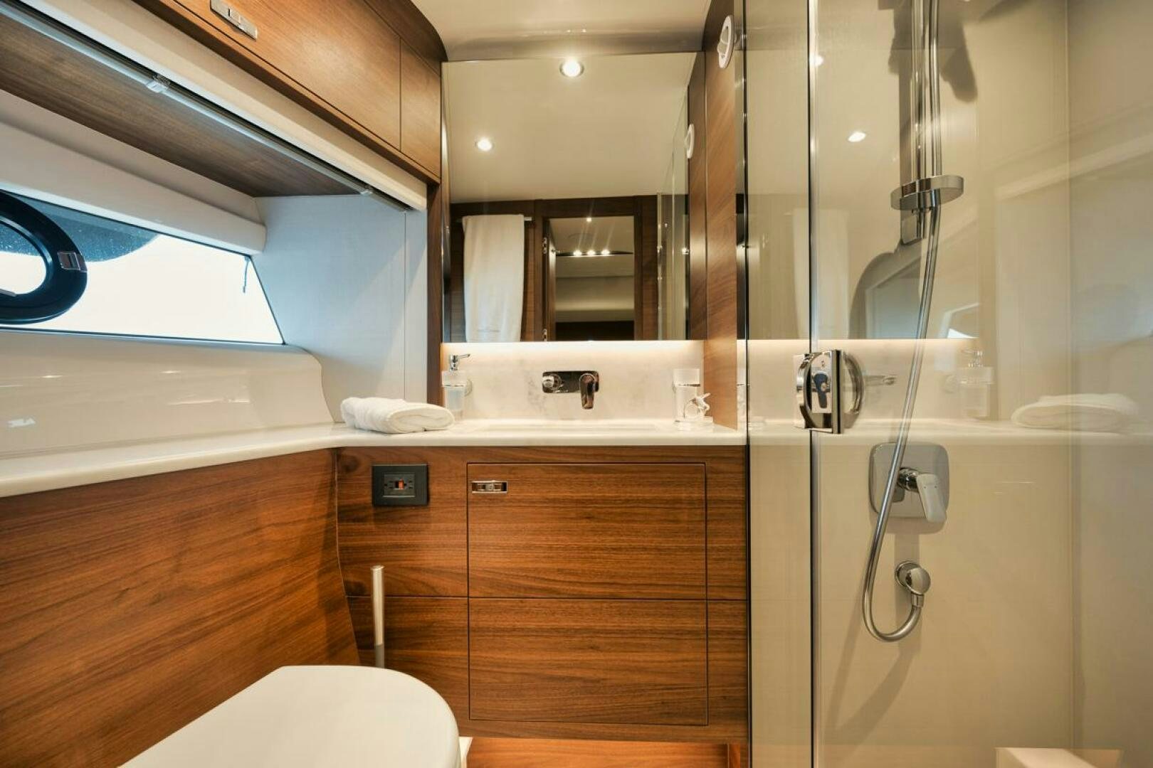 a bathroom with a glass shower aboard HOOKED HER Yacht for Sale