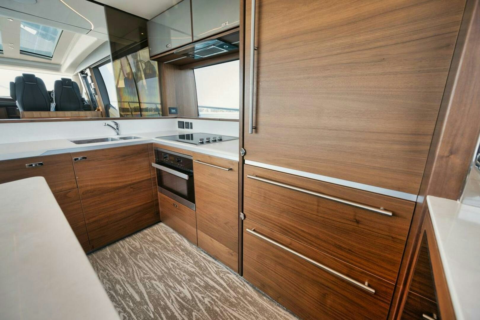 a kitchen with wooden cabinets aboard HOOKED HER Yacht for Sale