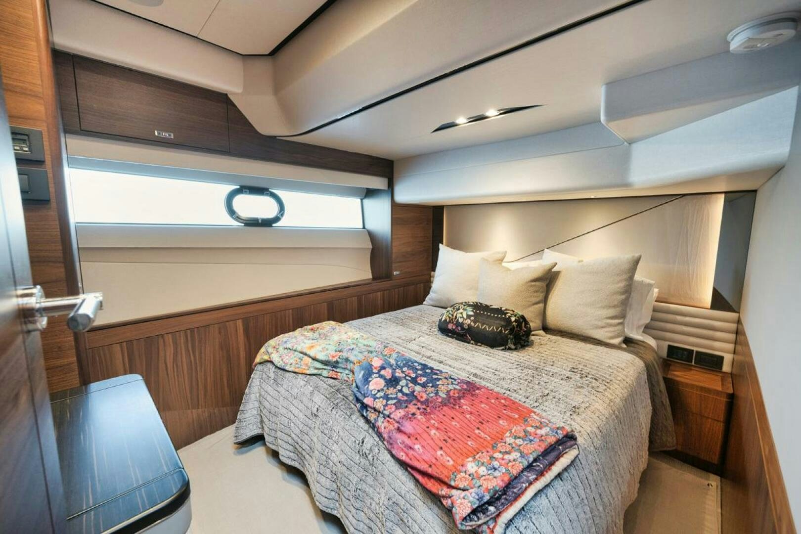 a bed with a pillow on it aboard HOOKED HER Yacht for Sale