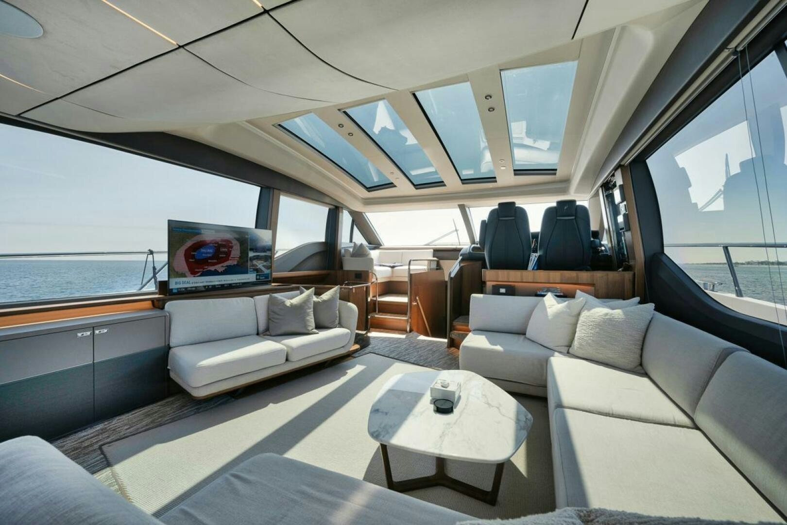 a room with a couch and a television in it aboard HOOKED HER Yacht for Sale