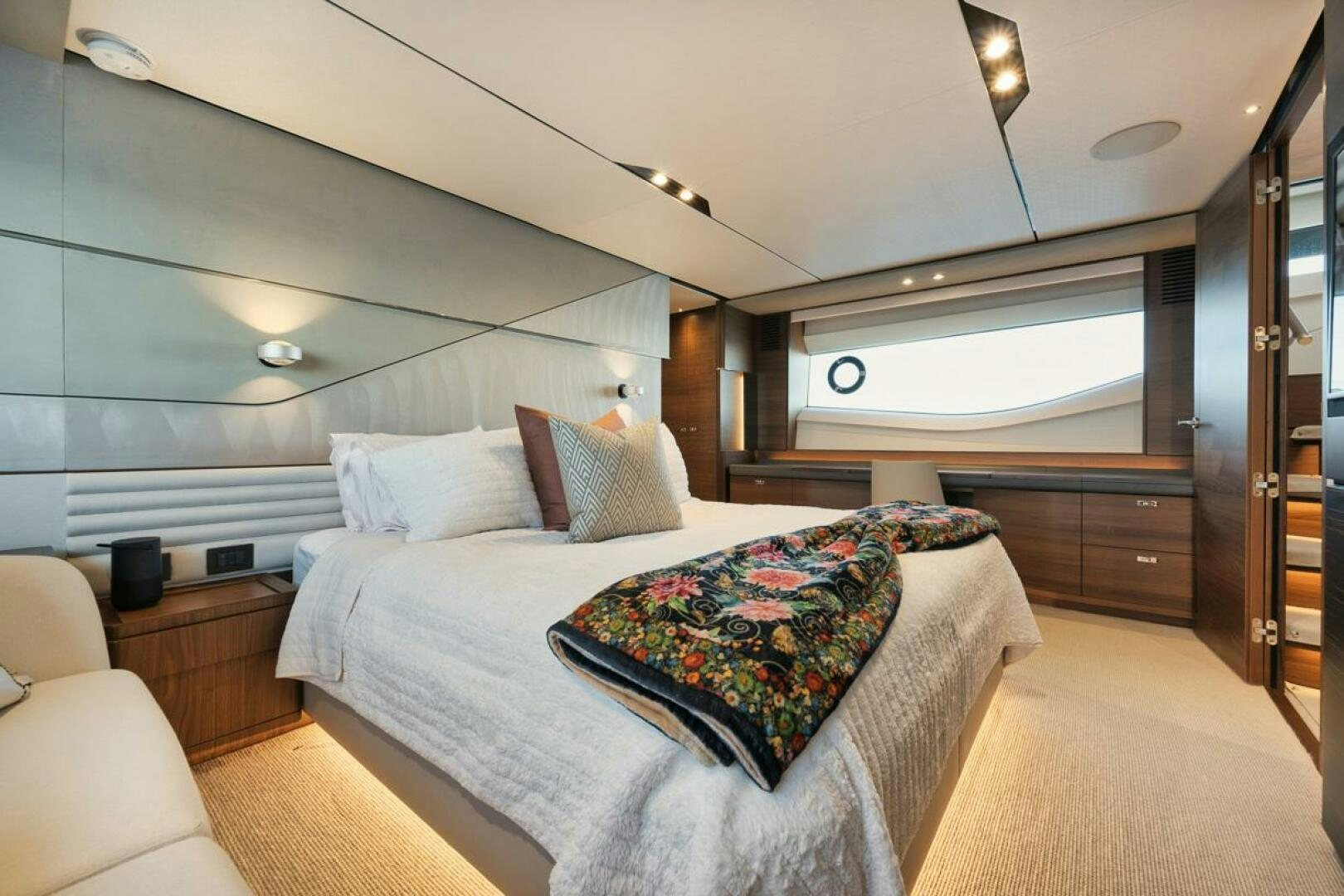 a bedroom with a bed and a desk aboard HOOKED HER Yacht for Sale